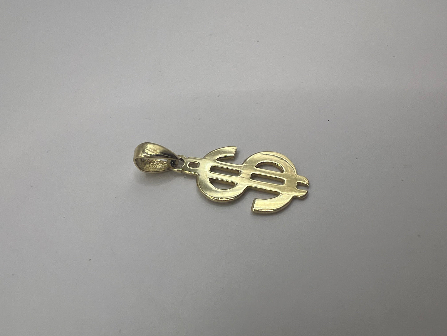 Dollár jel alakú arany medál ki